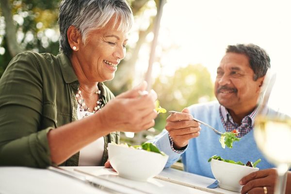 Healthiness and happiness go hand in hand Shot of a happy older couple enjoying a healthy lunch together outdoors