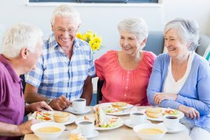Questions to Ask a Boca Raton Senior Living Community Group of Happy Seniors Eating Lunch_Sunscape™ Boca Raton