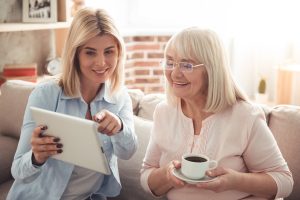Senior Woman and Adult Daughter Looking at Tablet_Sunscape™ Boca Raton