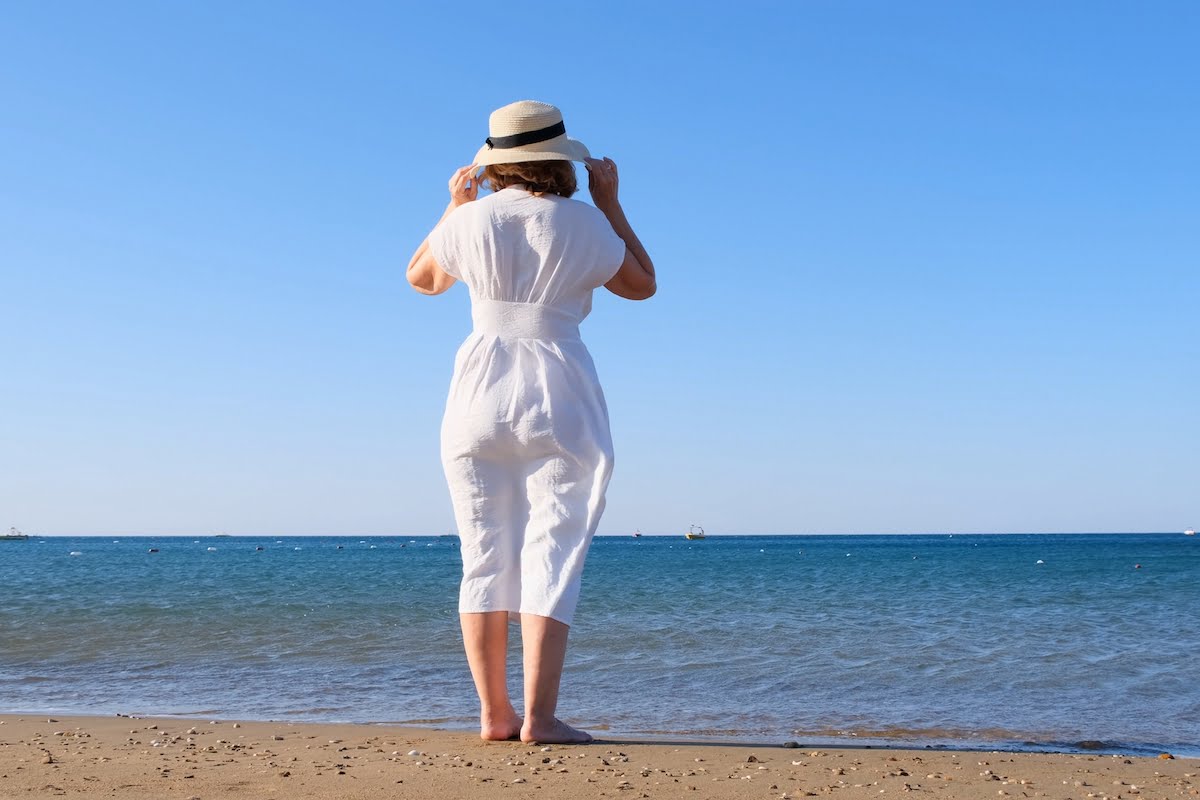 Back View Senior Woman Standing on Beach_Sunscape™ Boca Raton
