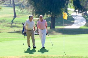 Two Senior Men Talking on the Golf Course_Health Benefits of Golf