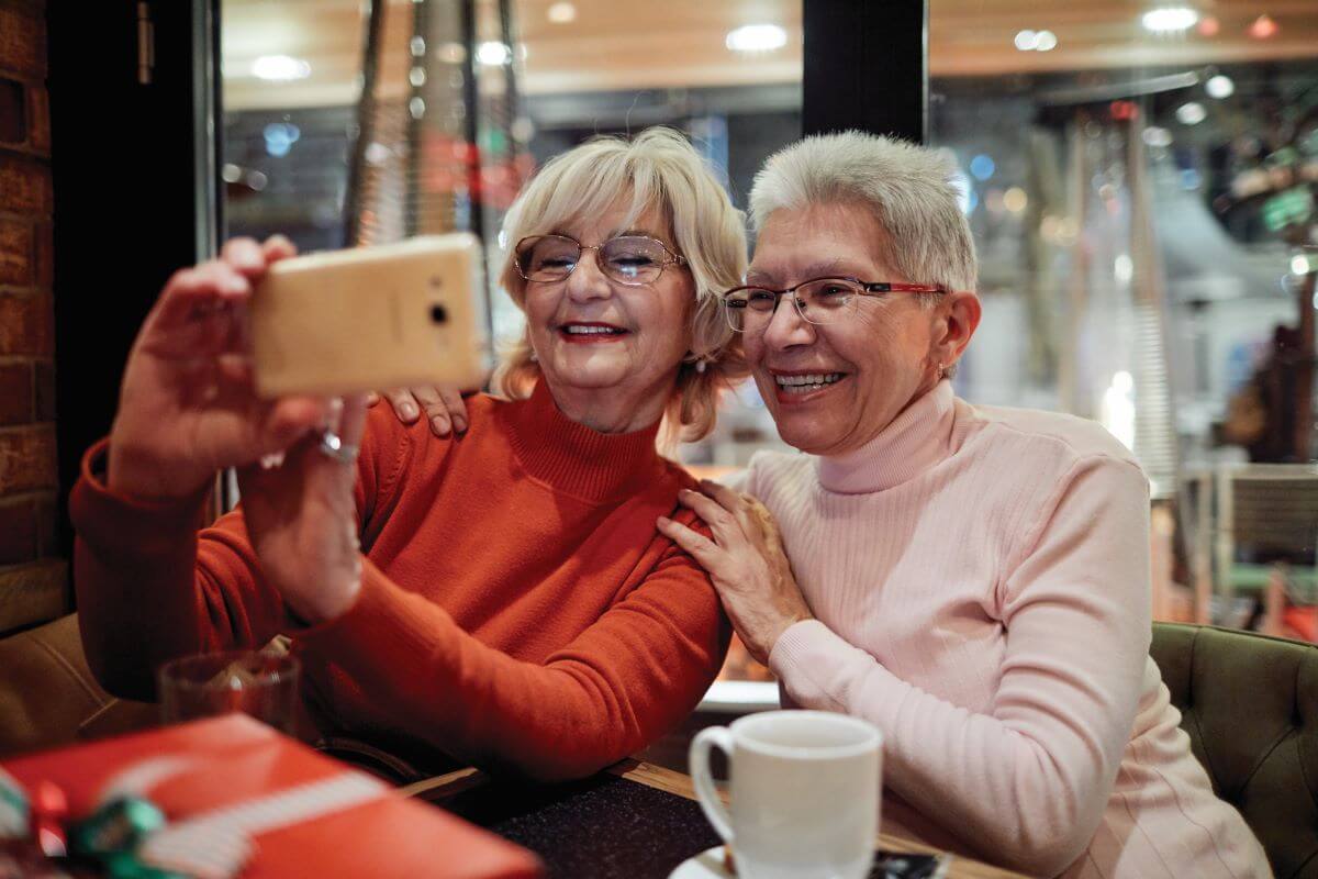 Senior taking selfie at Holiday Open House Sunscape Boca Raton