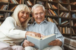 Embrace Healthy Aging: A Guide for Retirement Living Senior Couple Reading Together_Retirement Community in Boca Raton