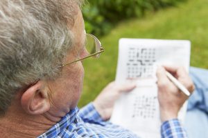Senior Man Completing Crossword Puzzle_Retirement Community in Boca Raton