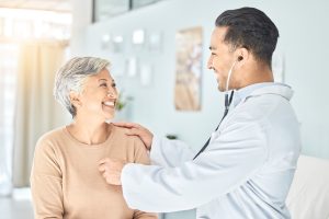 Male Doctor Listening to Senior Woman's Heart_Heart Health