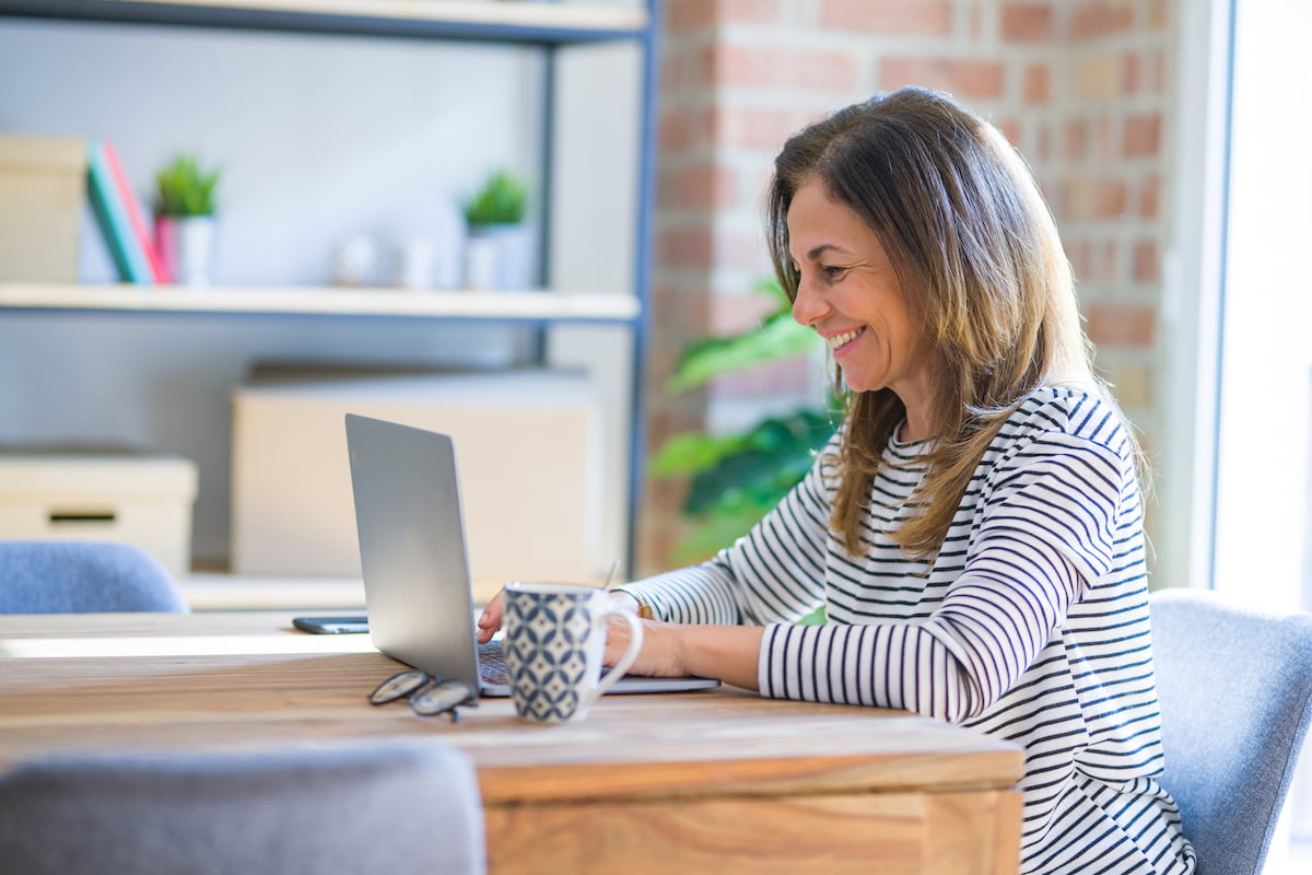 How to Start Your Boca Raton Senior Living Search Smiling Mature Woman Looking at Laptop_Boca Raton Senior Living