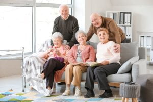 What to Look for During an Assisted Living Tour in Boca Raton Picture of five seniors at an assisted living community posing together.