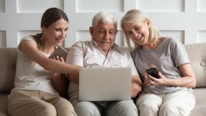 Making an Informed Decision About Boca Raton Assisted Living Older adults researching senior living options online with daughter.