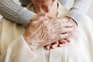 Making an Informed Decision About Boca Raton Assisted Living Caregiver taking the hand of an older adult.