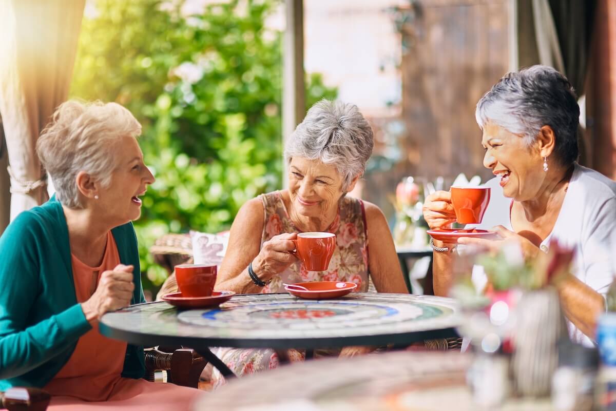 Why Socialization Matters & How Boca Raton Senior Living Helps Happy Older Women Socializing and Drinking Coffee