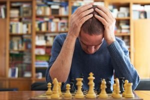 10 Ways Memory Care in Boca Raton Can Delay Cognitive Decline Older adult frustrated with a chess board