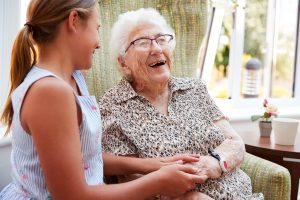 Older woman laughing with a kid