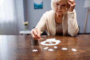 Older woman putting a puzzle together