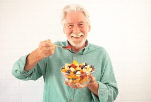How Sleep Changes with Age & How to Implement Better Habits Older man eating healthy