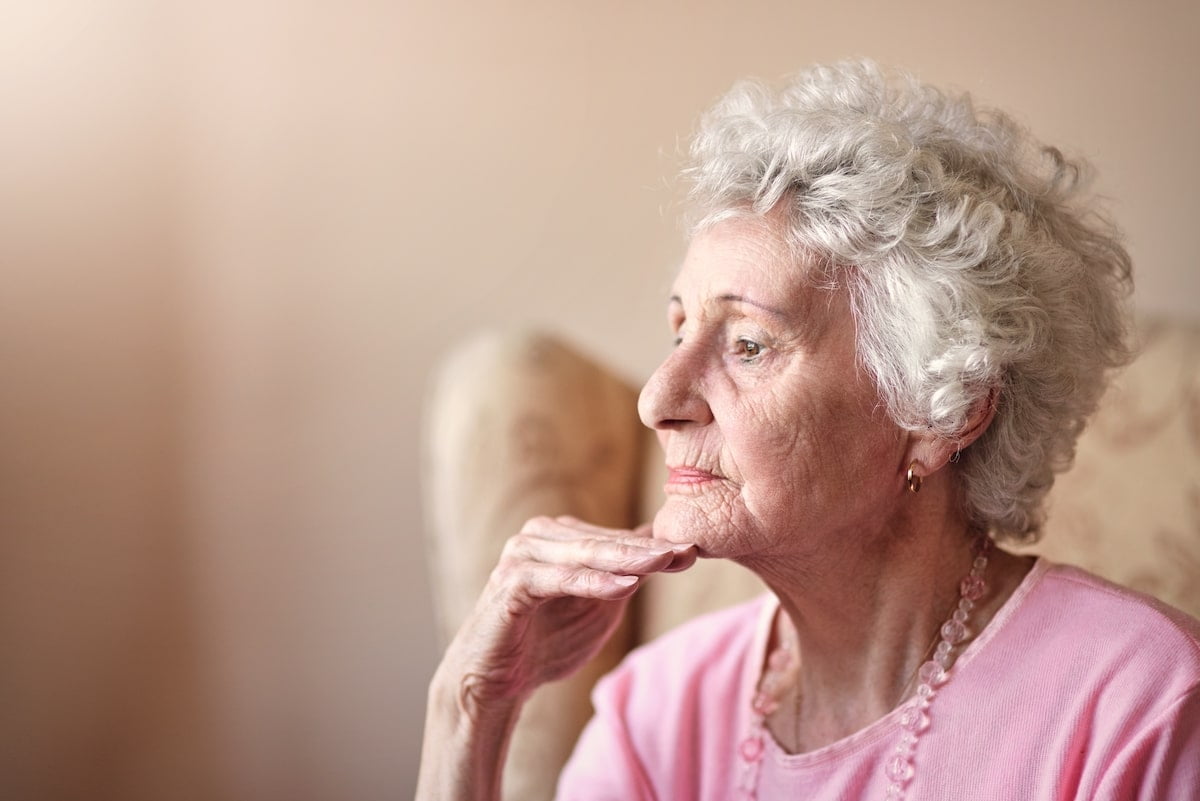 The Truth About What Causes Memory Loss Older woman in a thoughtful pose.