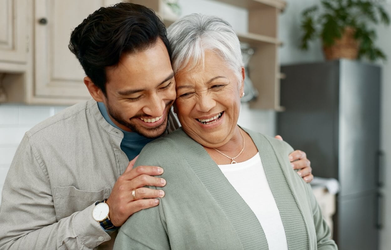 5 Tips for Balancing a Family Member’s Safety and Dignity Home senior mother and son with hug for care comfort and assurance