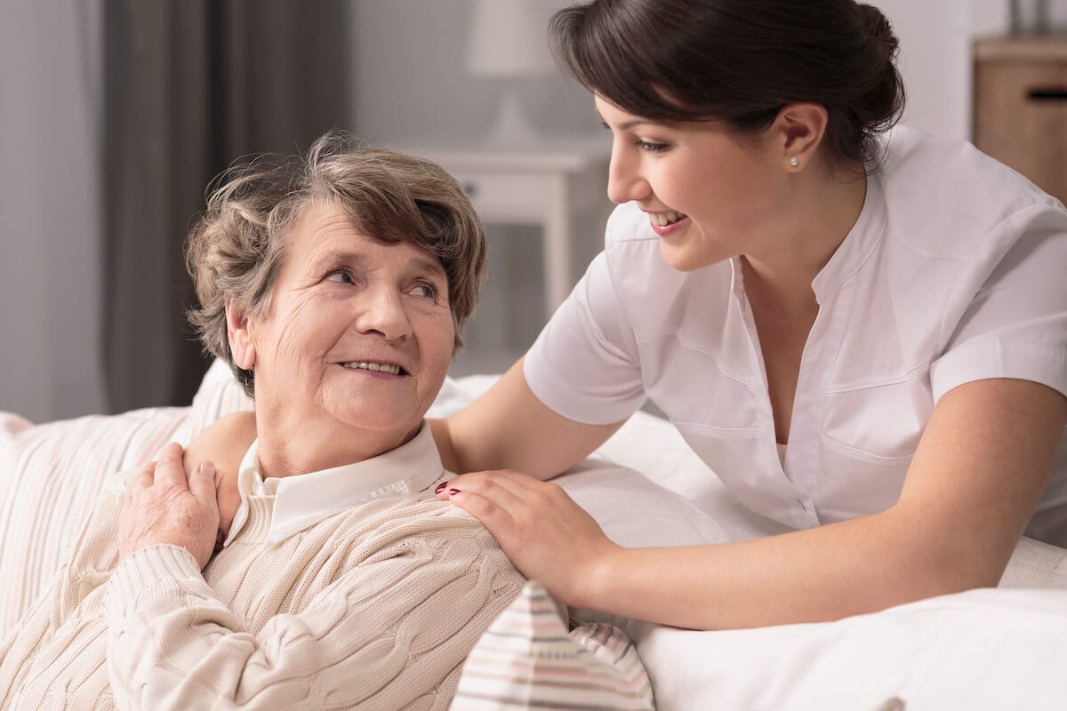 Should You Consider Assisted Living in Boca Raton? Caregiver comforting an older woman.