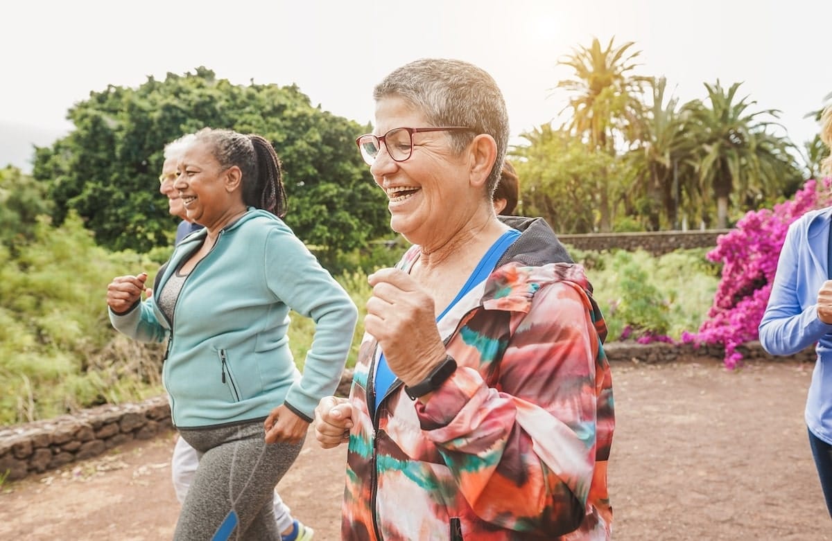How Senior Living in Boca Raton Empowers Older Adults Empowered older adults walking together.
