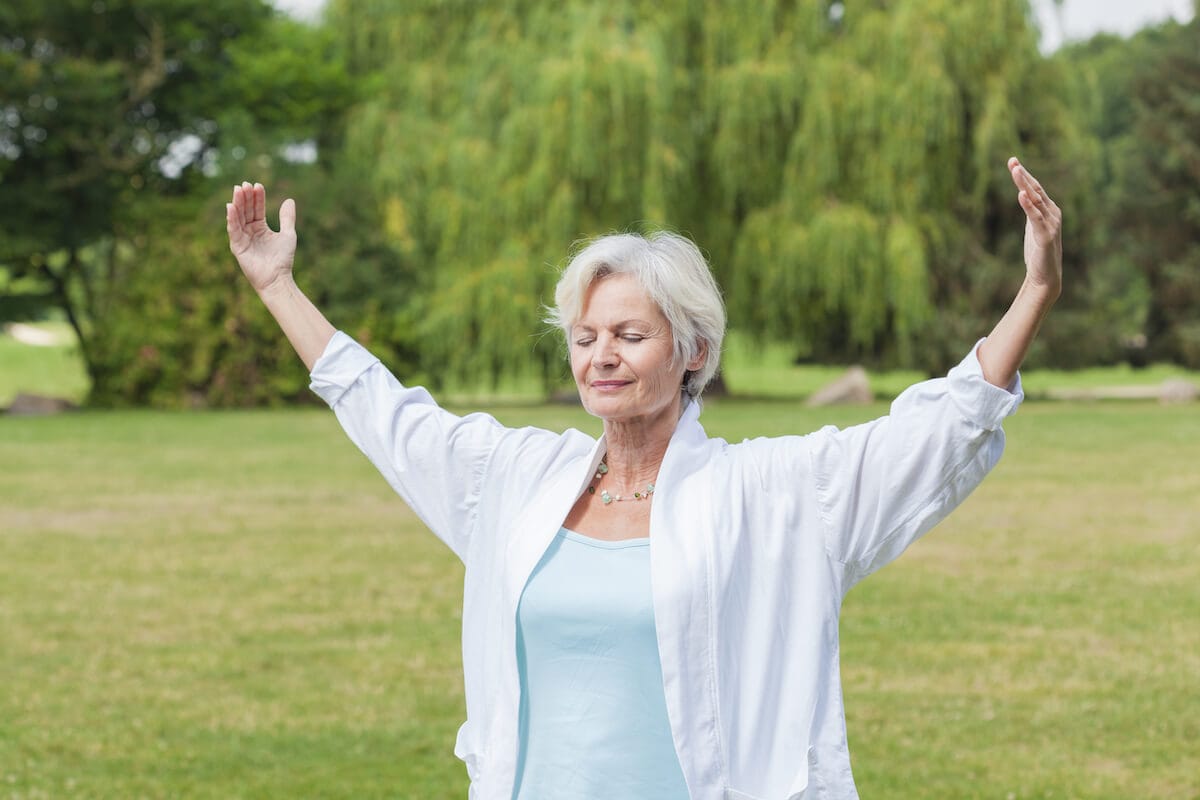 What is Holistic Wellness, and Why Does it Matter? Older woman relaxing outdoors.