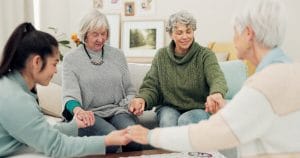 What is Holistic Wellness, and Why Does it Matter? Group of older women praying together