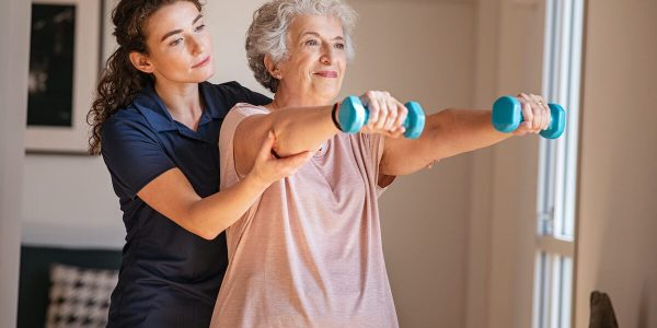 Older woman exercising with dumbbells.